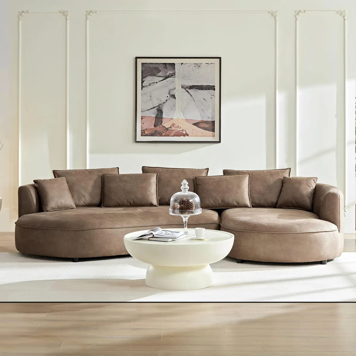 Large curved sectional sofa in brown fabric with multiple cushions and pillows
