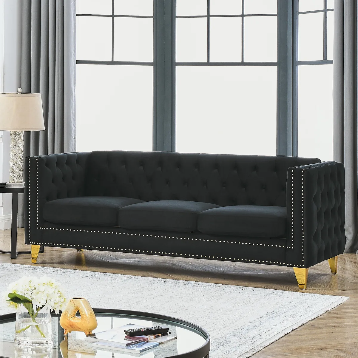 Black velvet Chesterfield sofa with tufted buttons, nailhead trim and metal legs