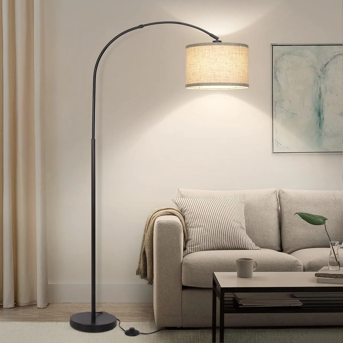 Black arc floor lamp with adjustable drum shade and heavy metal base