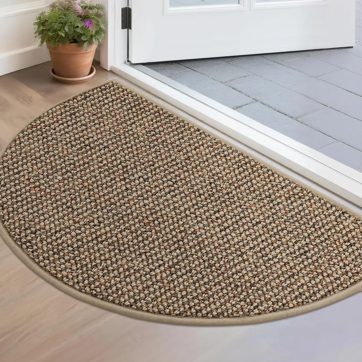 Half-circle taupe doormat with woven texture and low profile