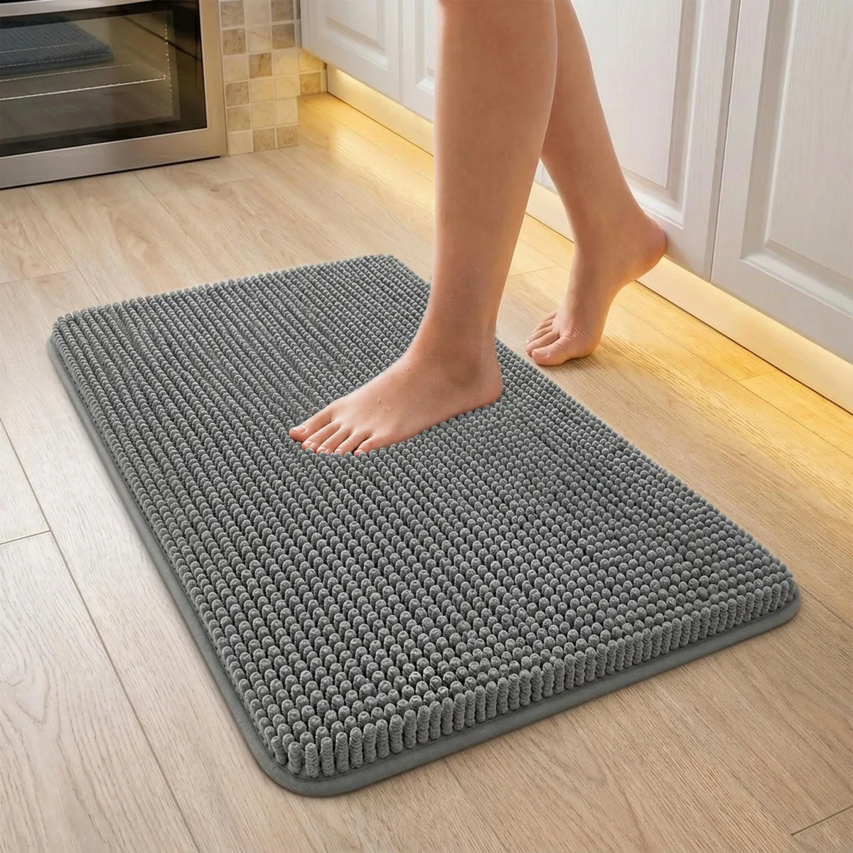 Rectangular grey polyester bath rug, 17 by 24 inches, fluffy chenille surface with non-slip backing