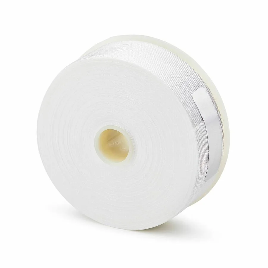 White replacement cassette roll for fiber optic cleaner, compact rectangular shape
