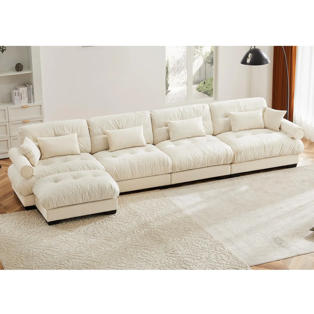 L-shaped cream velvet sectional sofa with bolstered armrests and scatter cushions
