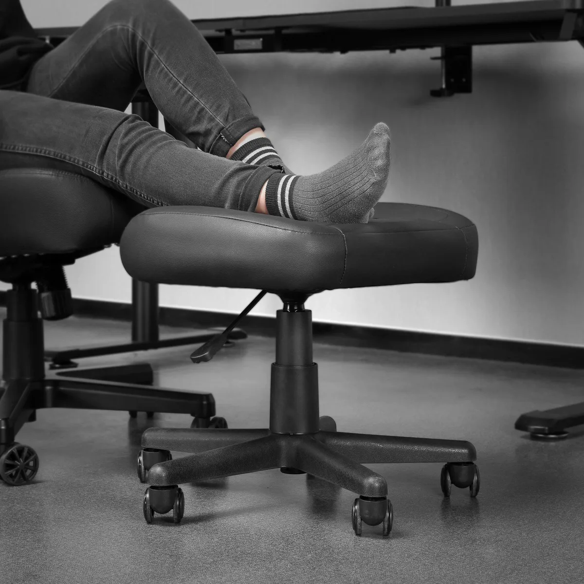 Black PU leather rolling footrest and stool on five caster wheels