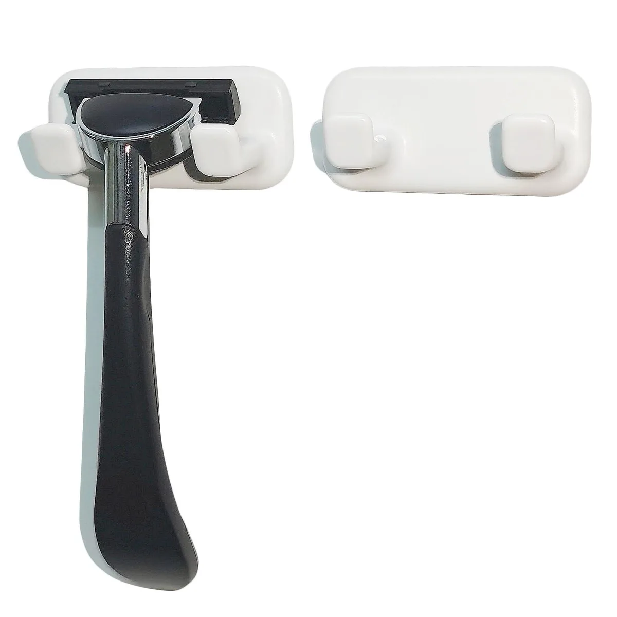 Two small white rectangular adhesive hooks with open slots