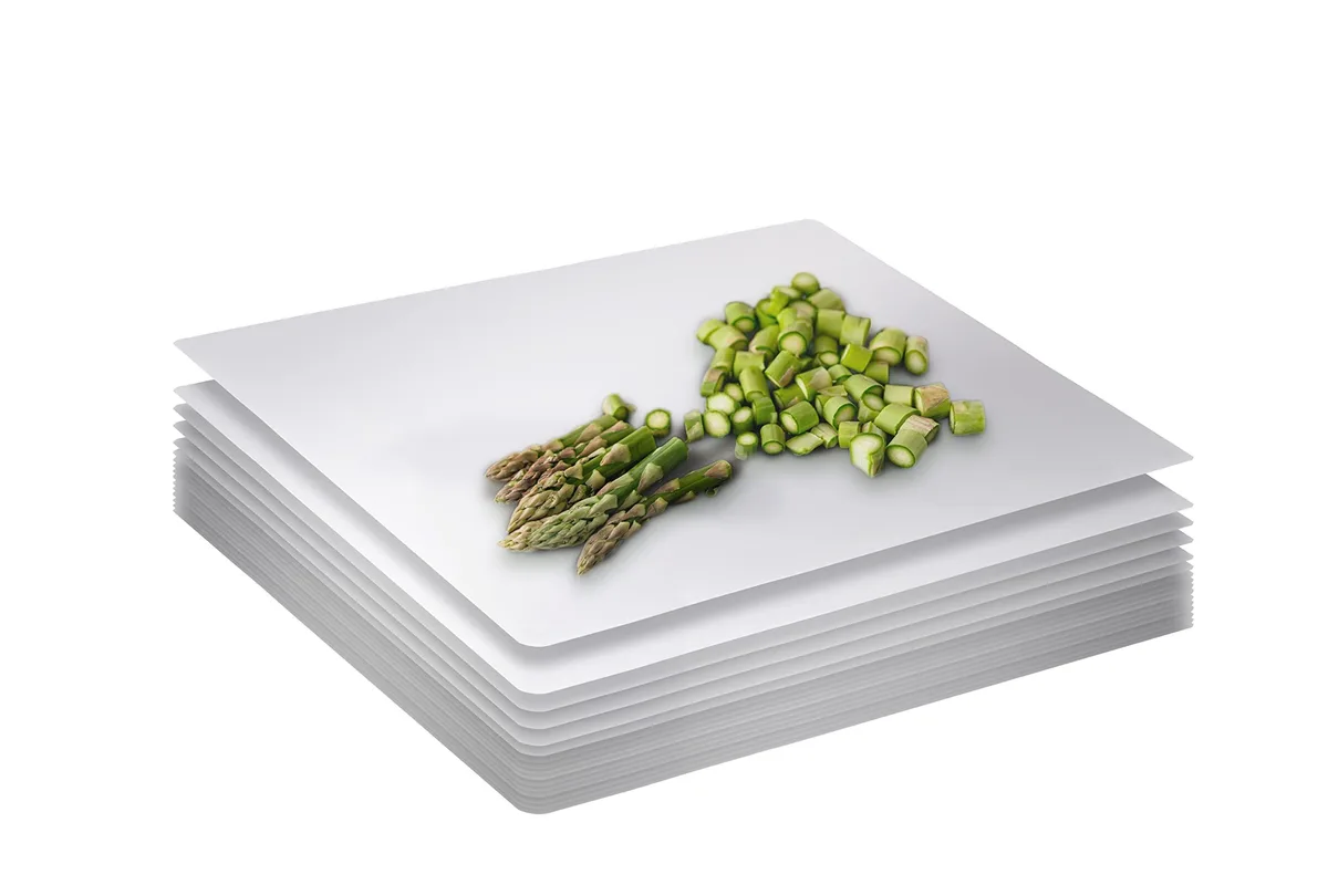 Stack of 25 thin white disposable cutting boards 17.76 by 12.05 inches