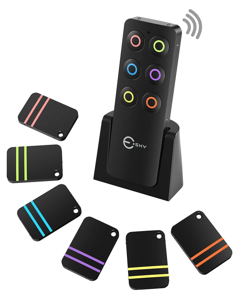 Black remote with six coin-size receivers attached by adhesive pads