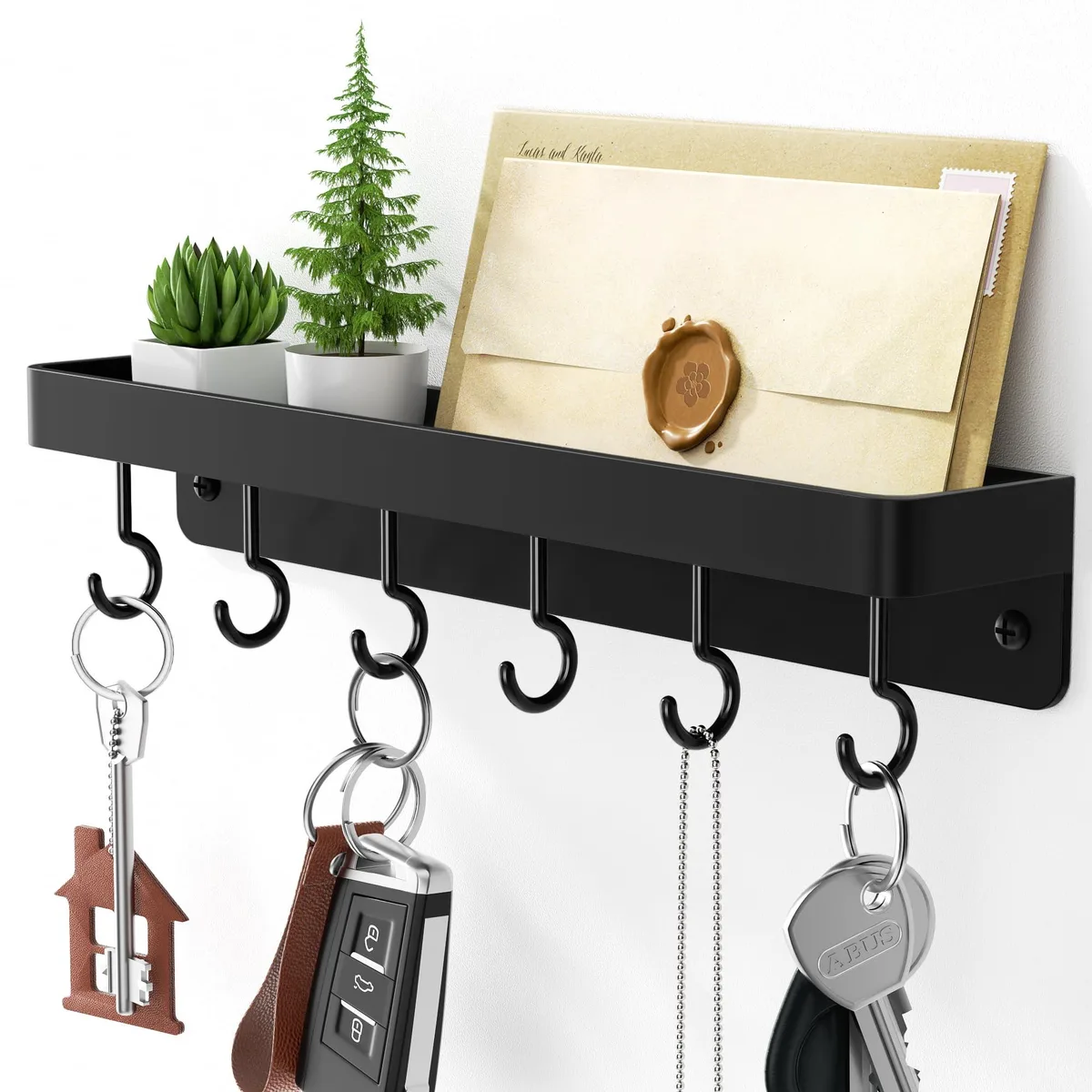 Black stainless-steel key rack with six curved hooks, top shelf, self-adhesive backing