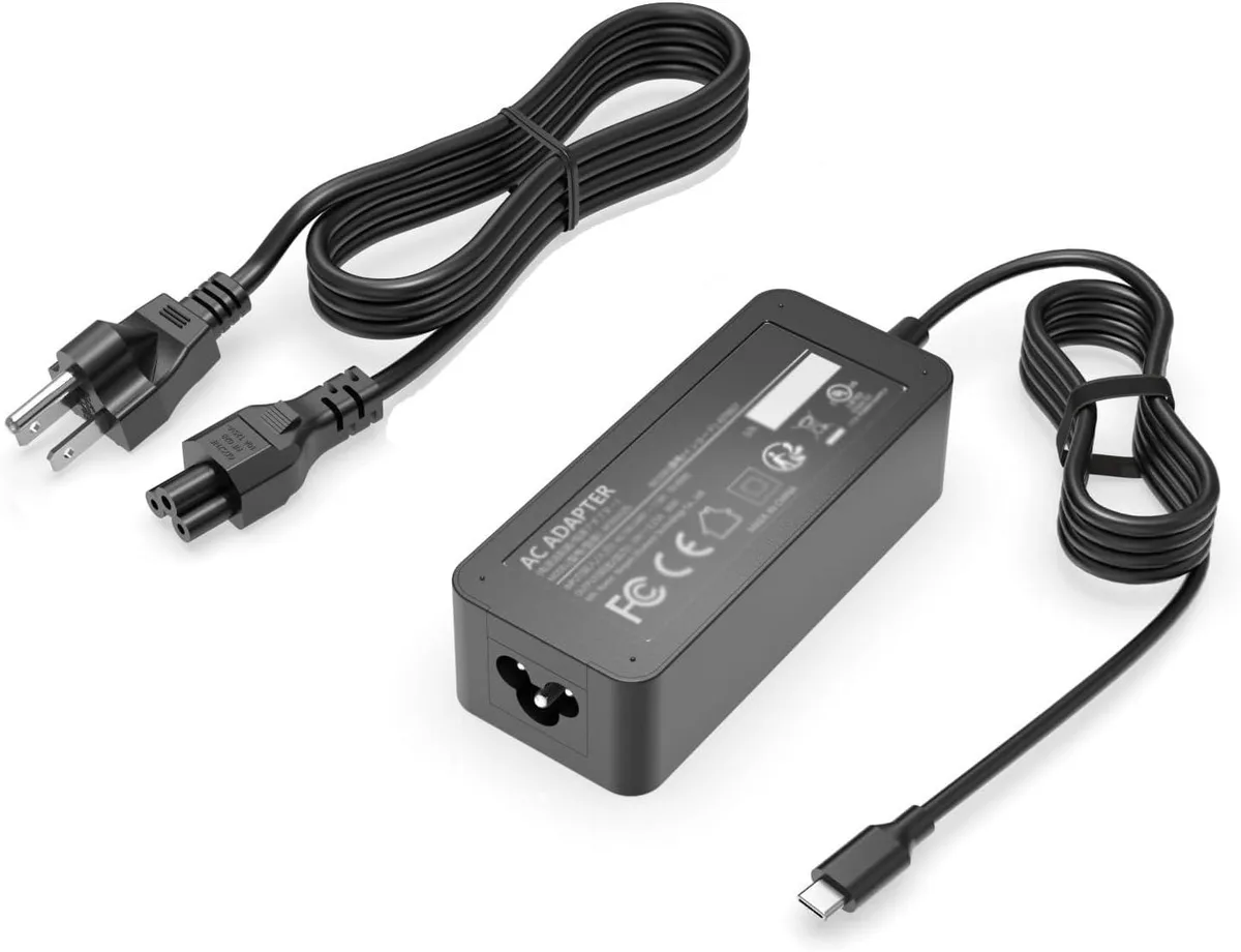 A white rectangular USB-C power adapter with a long black cable and three-prong plug