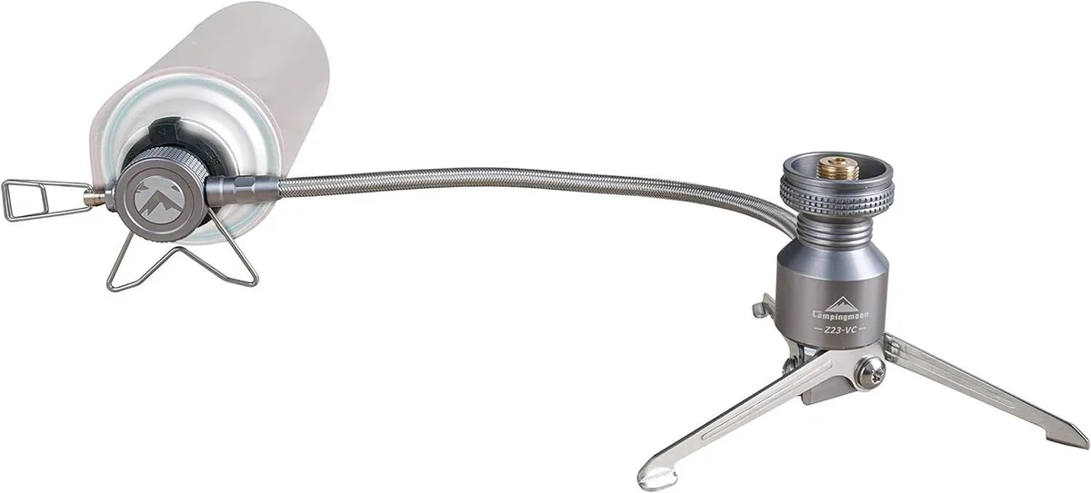 A compact metal butane adapter with a braided hose and fold-out stand legs