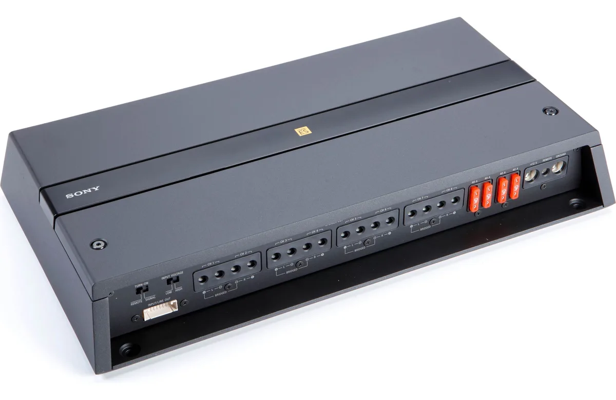 Rectangular silver car amplifier with eight channels and bass remote