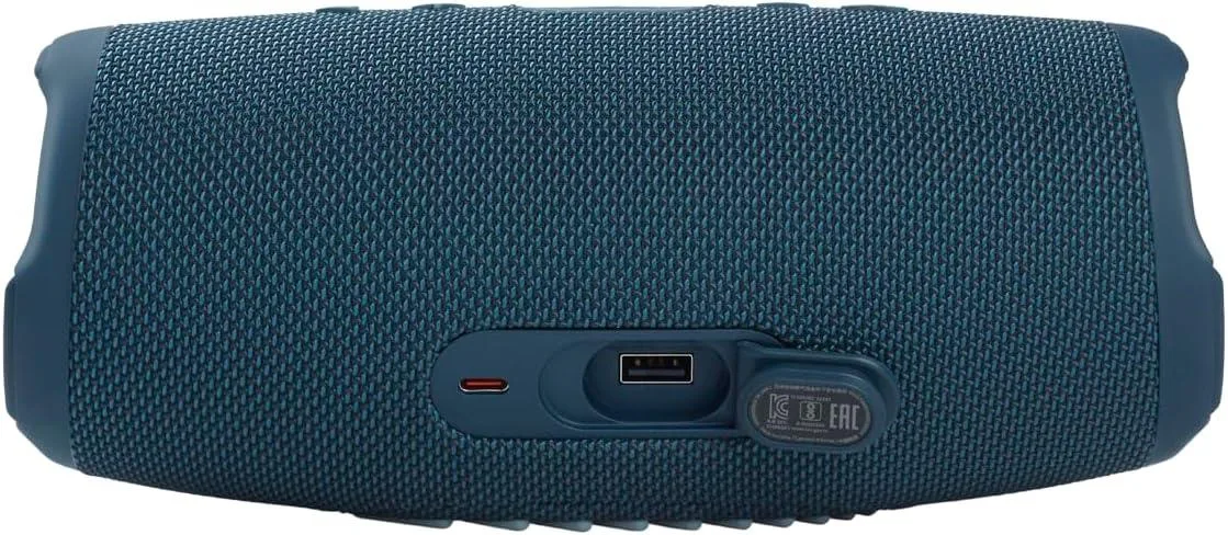 Blue cylindrical portable speaker with fabric wrap and rubber ends