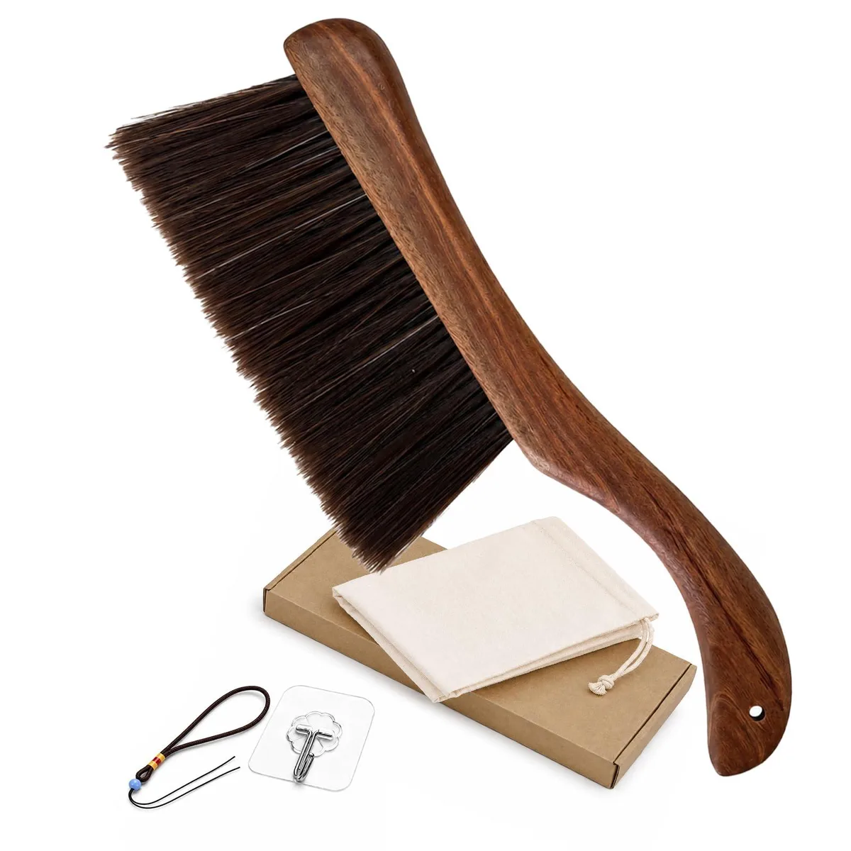 Curved wooden handle hand broom with four rows of white bristles and drawstring bag