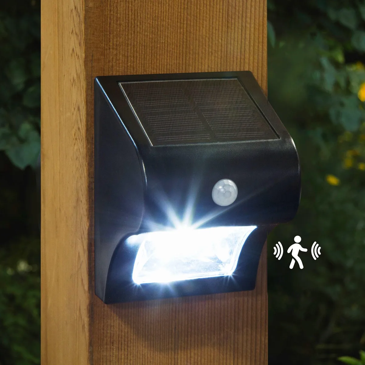 Two compact black rectangular solar lights with motion sensors and surface-mount LEDs