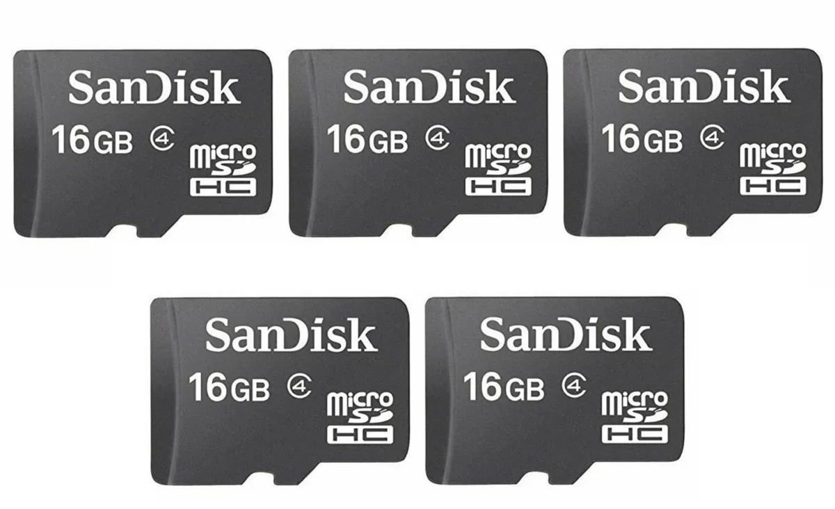 Five small black microSD cards with red labels