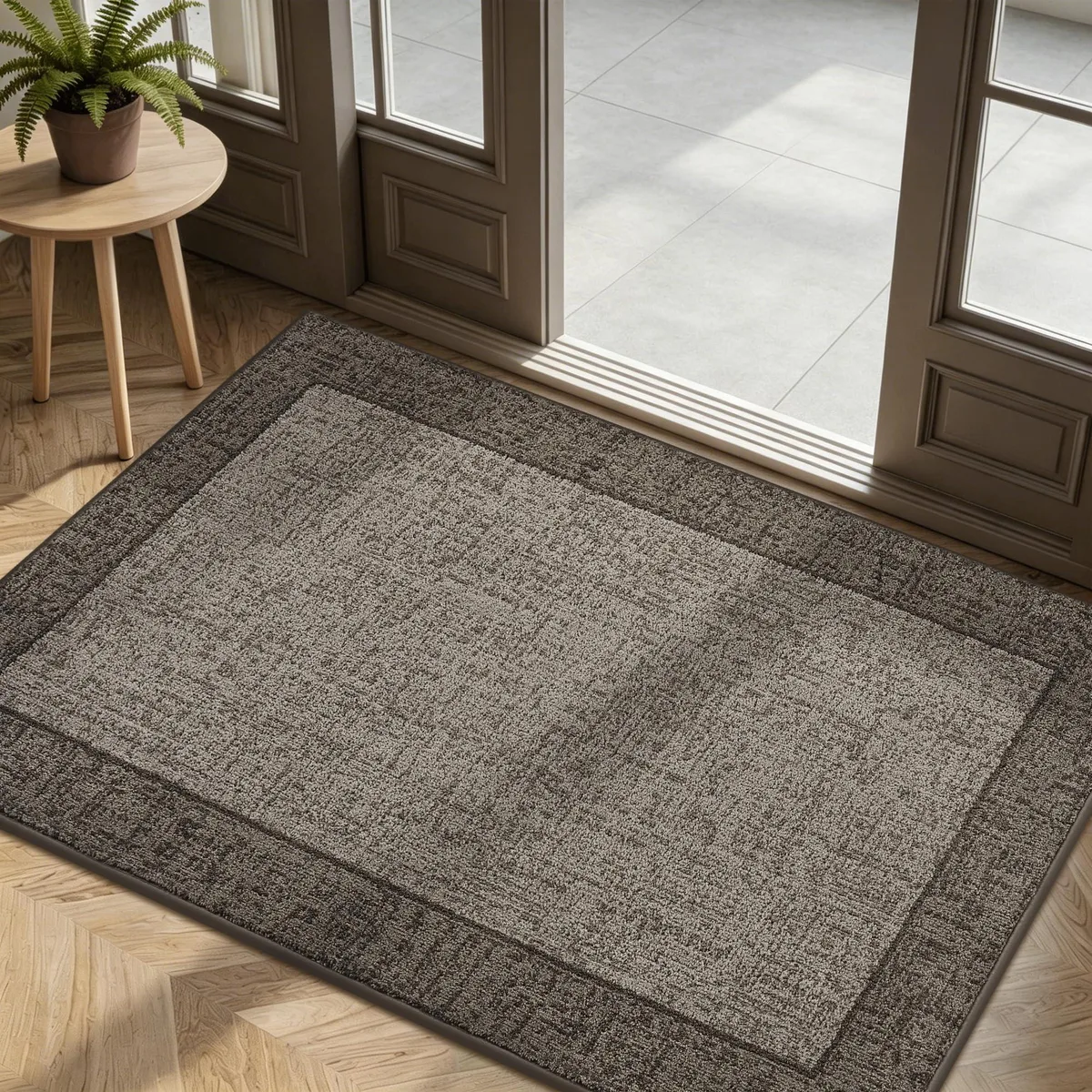Taupe rectangular door mat, low-profile woven surface with reinforced edges, non-slip backing visible underneath