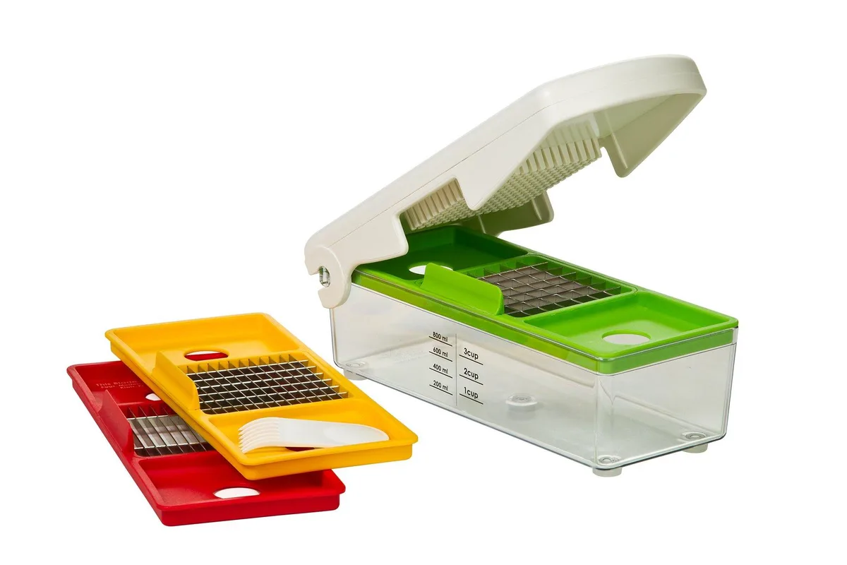 White manual fruit and vegetable chopper with interchangeable stainless steel blades and measuring container