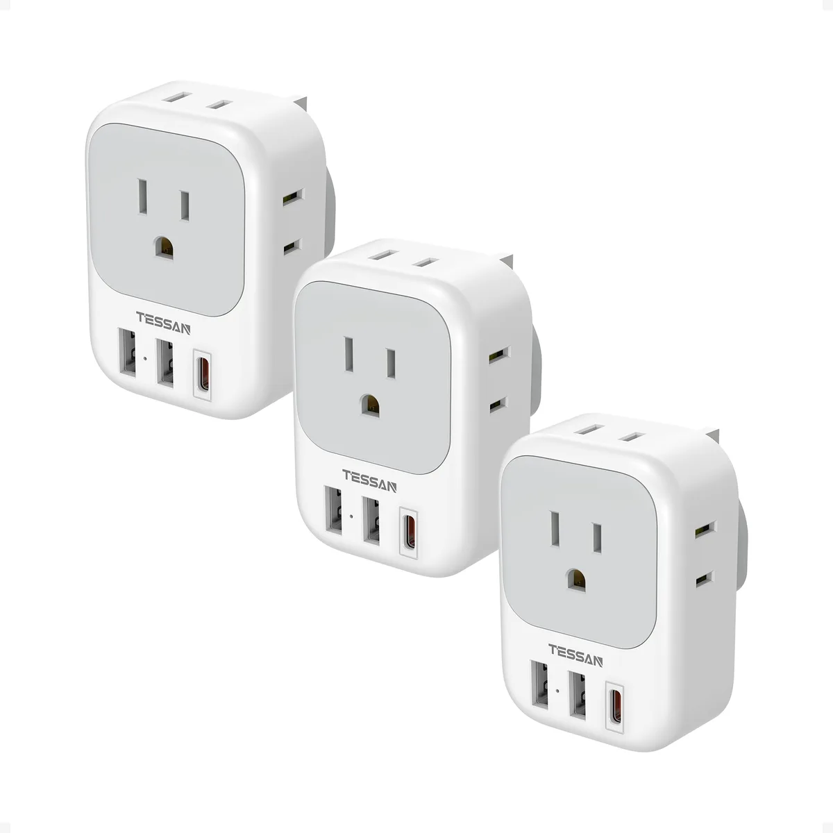 Three grey UK travel adapters with USB-C and USB-A ports