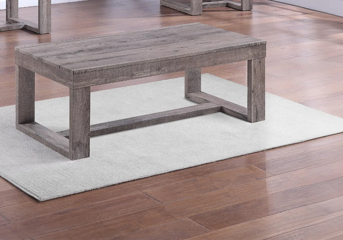 Rectangular wood coffee table with rustic brown, gray and tan finish and double pedestal base