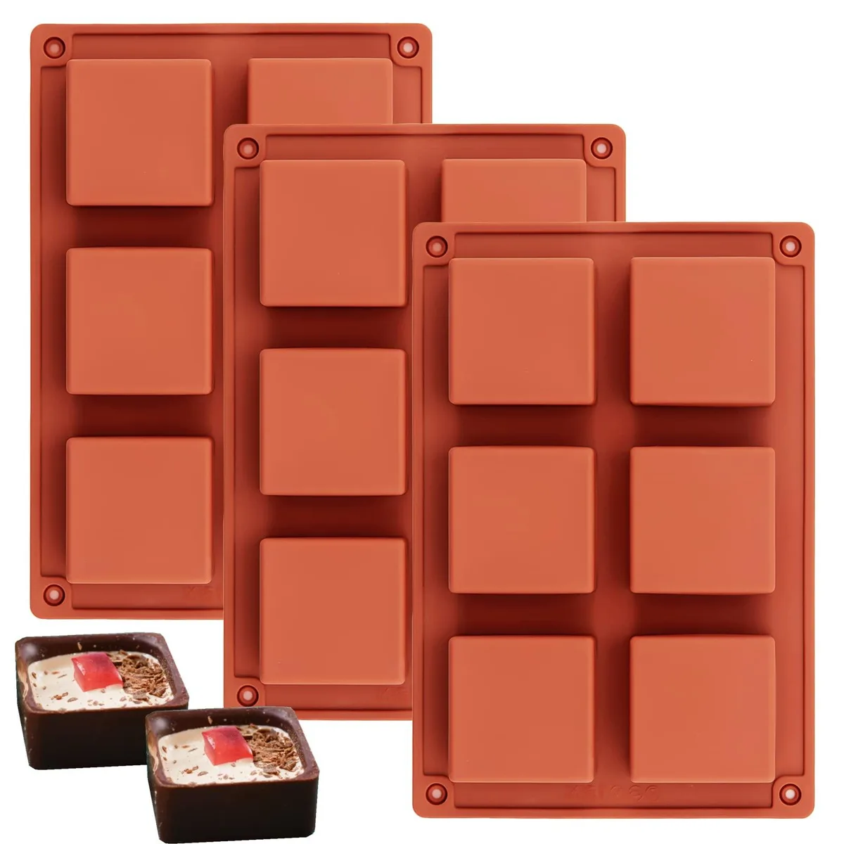 Three square silicone brownie pans, each with six cavities, light-coloured flexible material