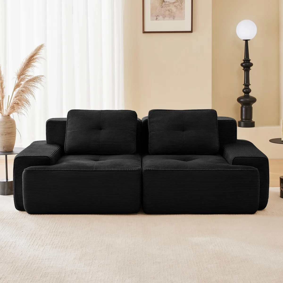 Black corduroy L-shaped modular sofa, 82 inches wide, deep seat with tufted detailing and curved armrests