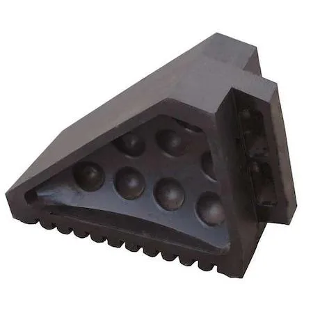 Black molded rubber wheel chock with grooved base, smooth top, carrying handle and grip bottom