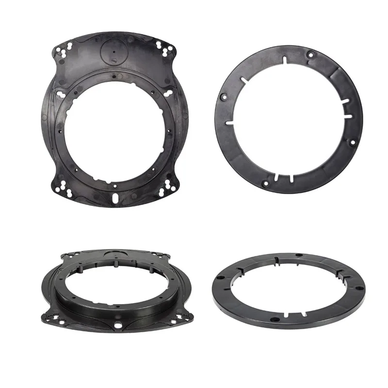 A pair of black plastic universal speaker mounting adapters