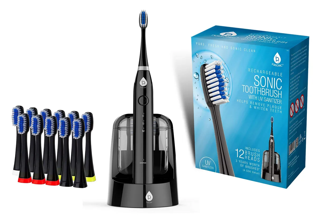 Black sonic toothbrush handle with charging base and multiple brush heads