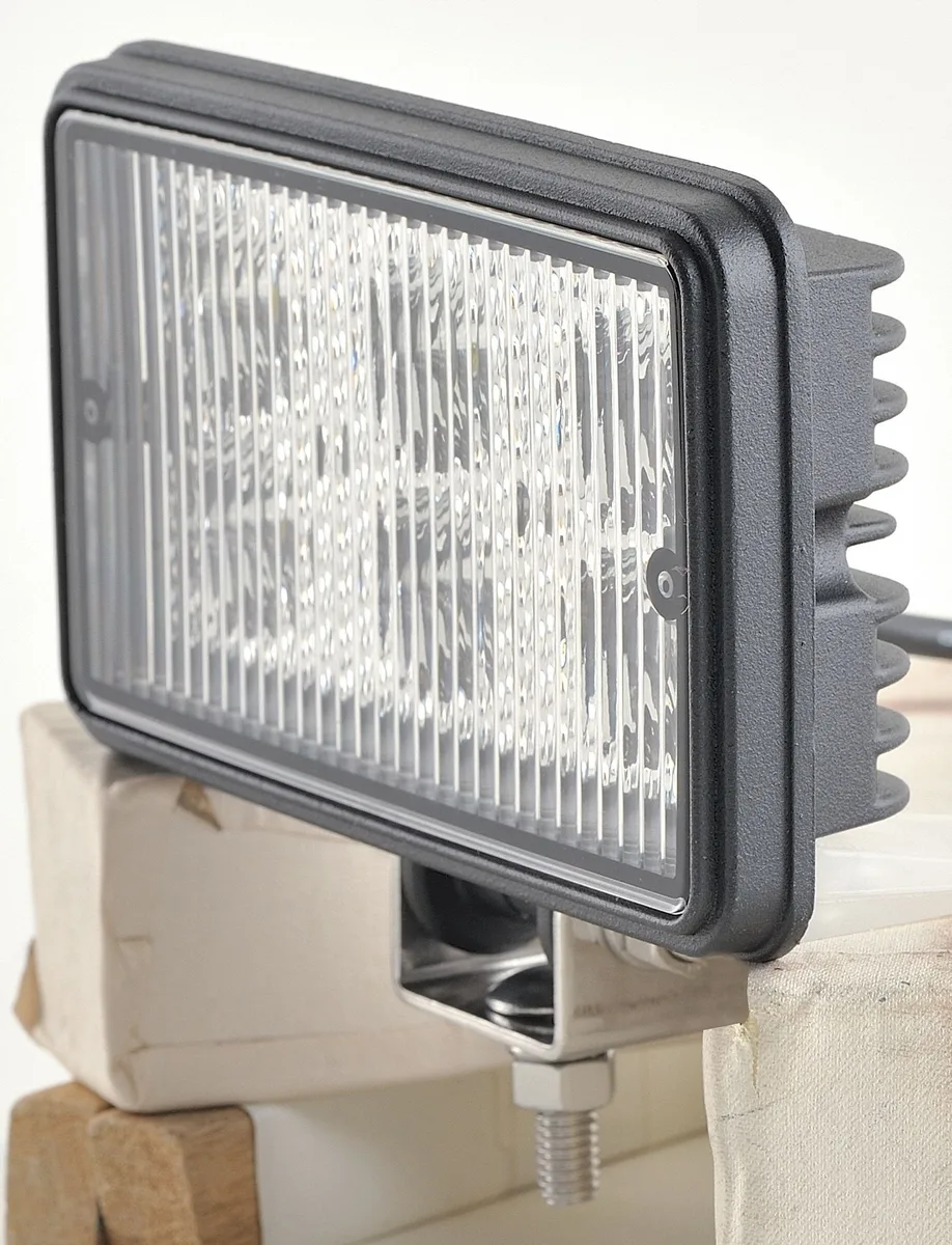 Rectangular black housing with clear lens flood light