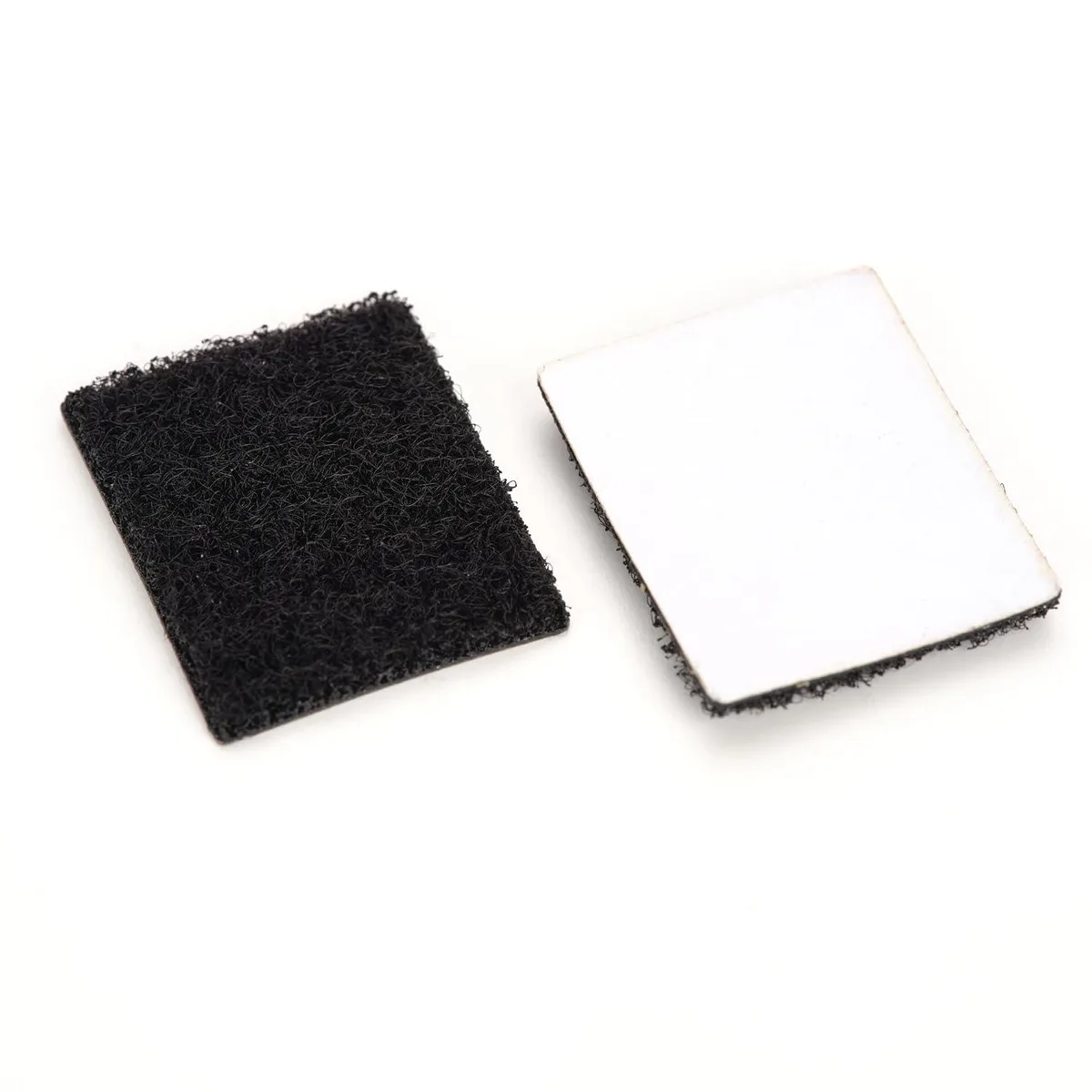 Two adhesive-backed hook-and-loop pads, rectangular, matte finish