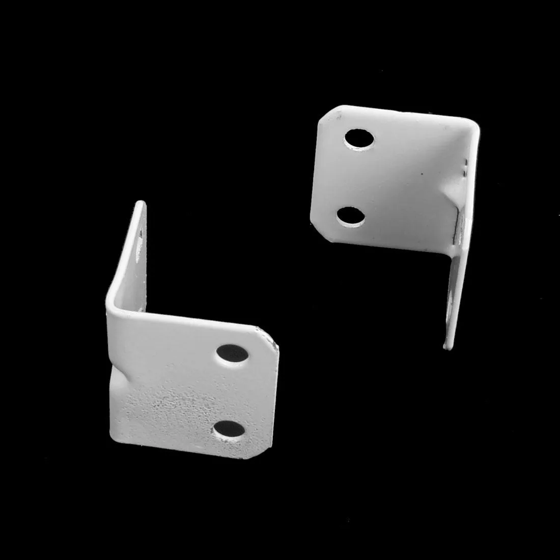 Four white L-shaped metal brackets with rounded edges and mounting holes