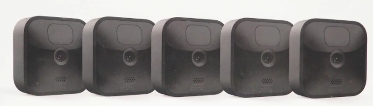 Five white square outdoor cameras with mounts and a sync module