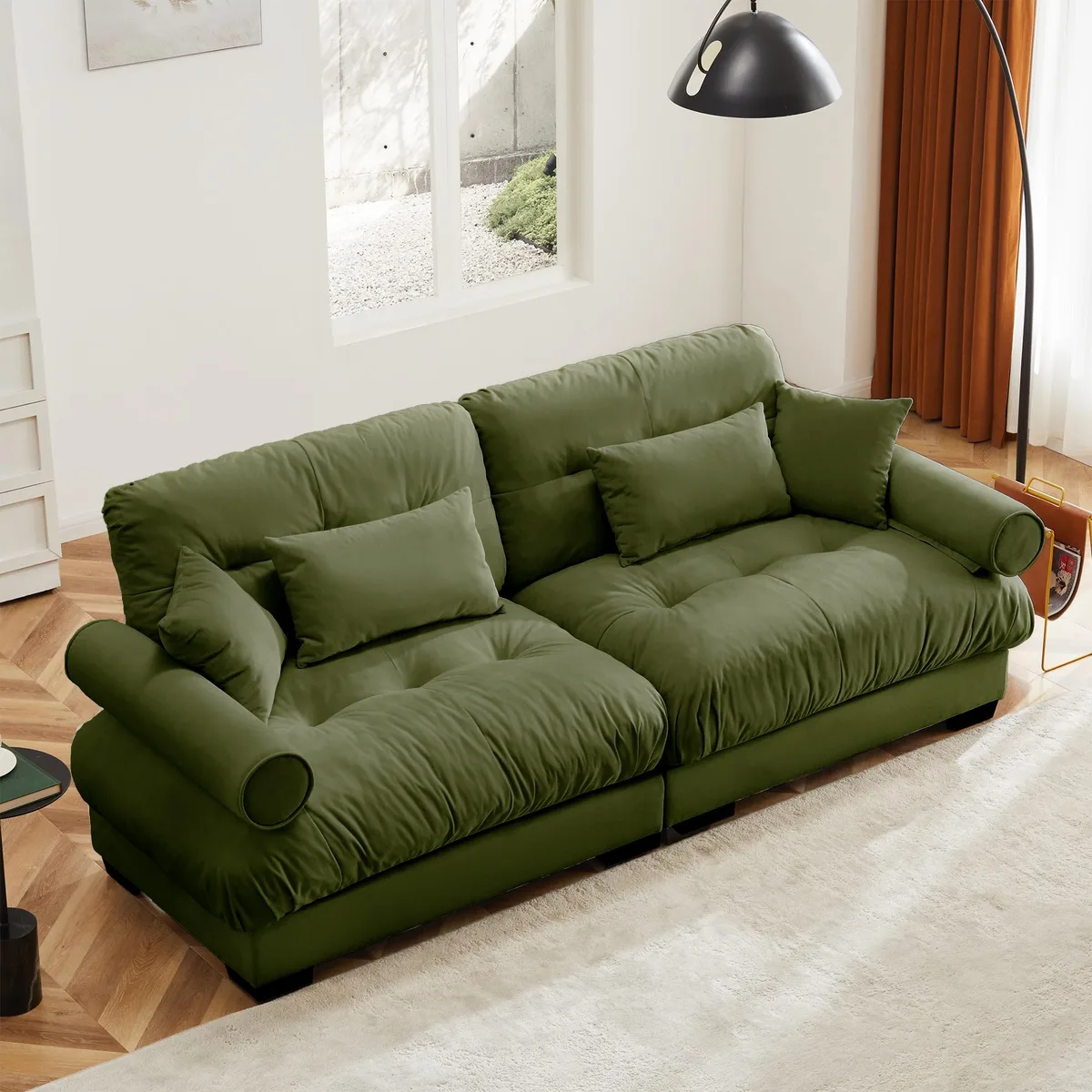 Olive green velvet two-seater sofa with bolstered armrests, waist and throw pillows