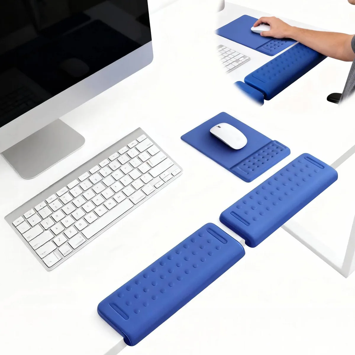 Three thin L-shaped fabric cushions and a rectangular wrist rest lying flat on a desk surface