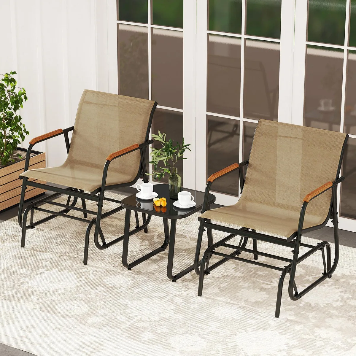 Coffee-coloured metal frame glider with two grey seats, teak armrests and matching glass-top side table