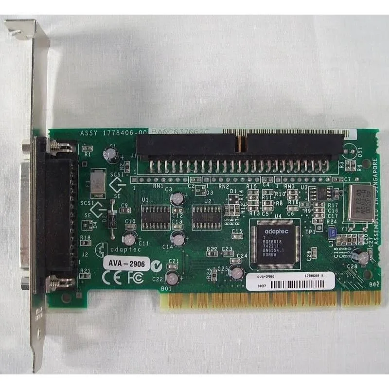 Green printed circuit board with silver 32-bit PCI edge connector and two SCSI ports