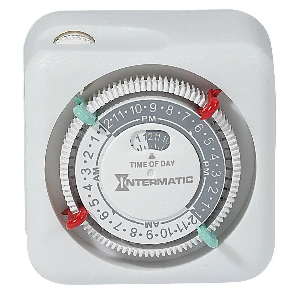 White rectangular plug-in timer with dial and override switch