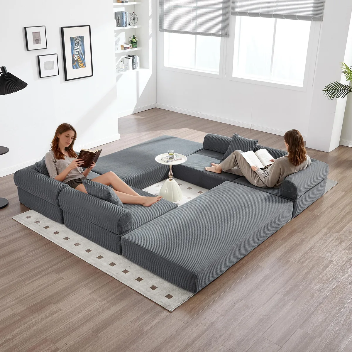 Gray corduroy convertible folding sofa bed with fixed frame, L-shaped armrests, and detachable storage pockets