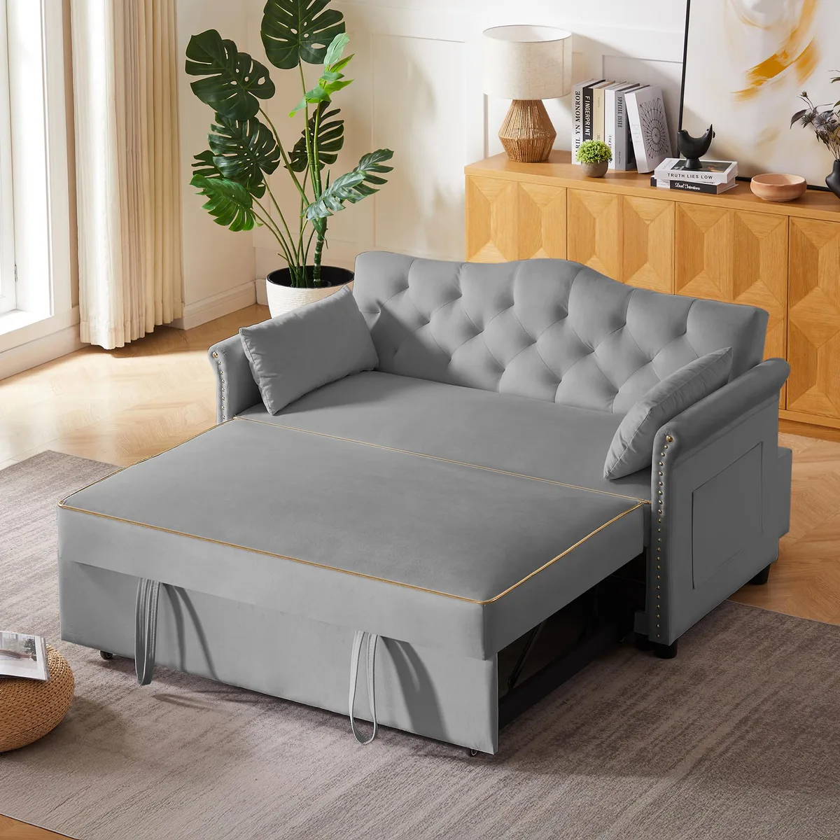 Grey velvet sleeper sofa with tufted back, nailhead trim armrests, plastic legs, converts to bed