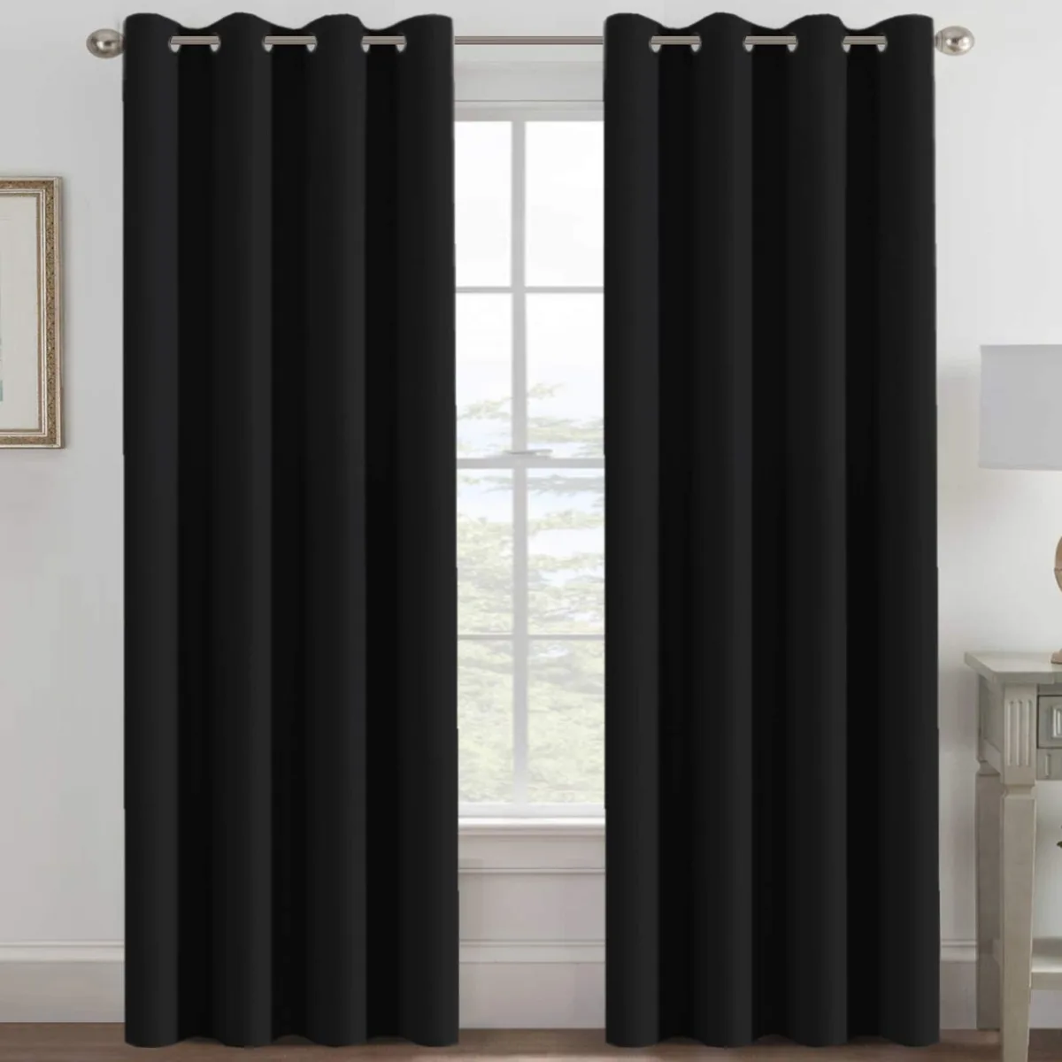 Single jet-black curtain panel with eight metal grommets along the top edge
