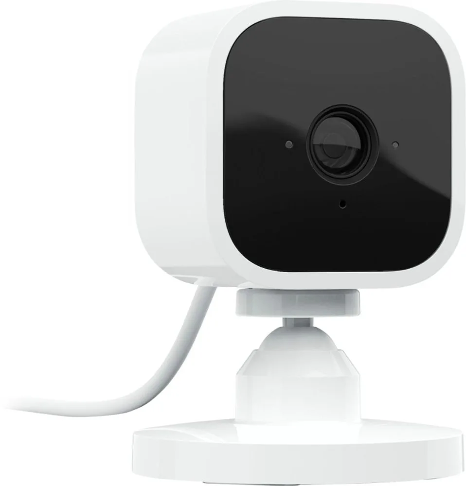 Small white cube indoor camera with rounded edges, USB power cable attached