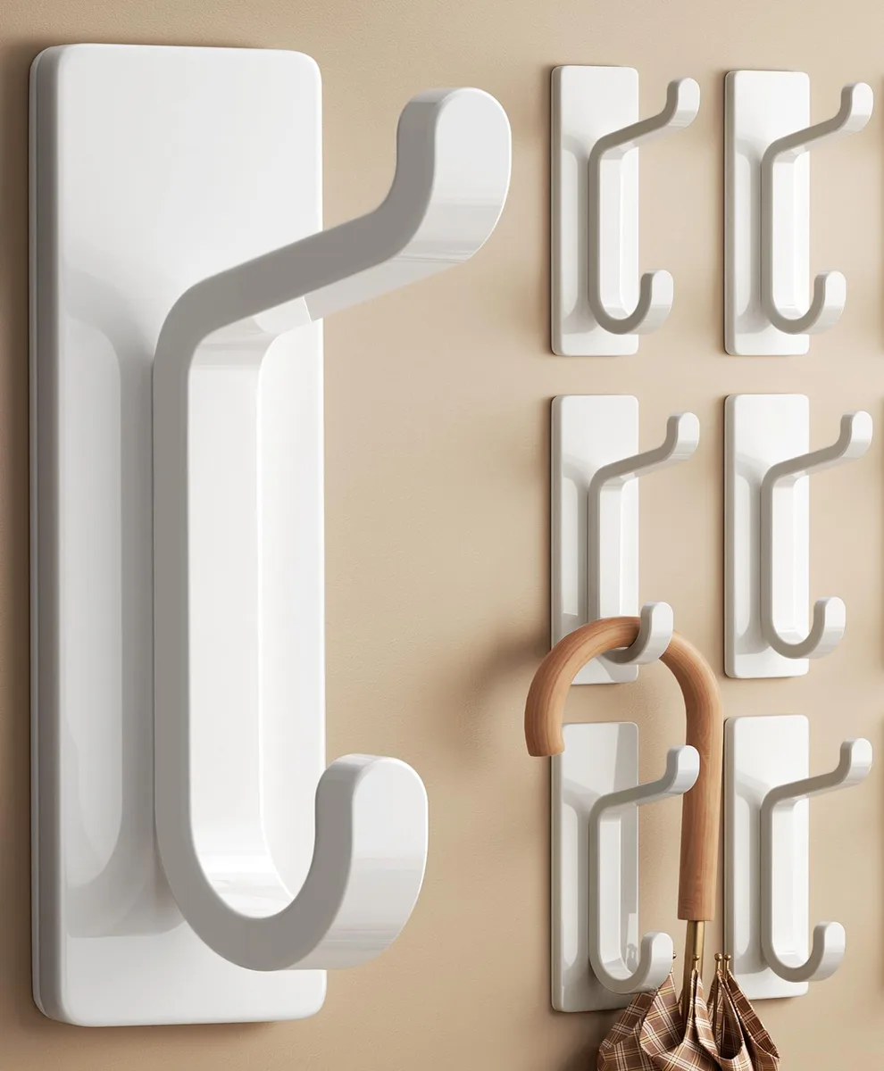 Six white adhesive double hooks, twelve hook ends total