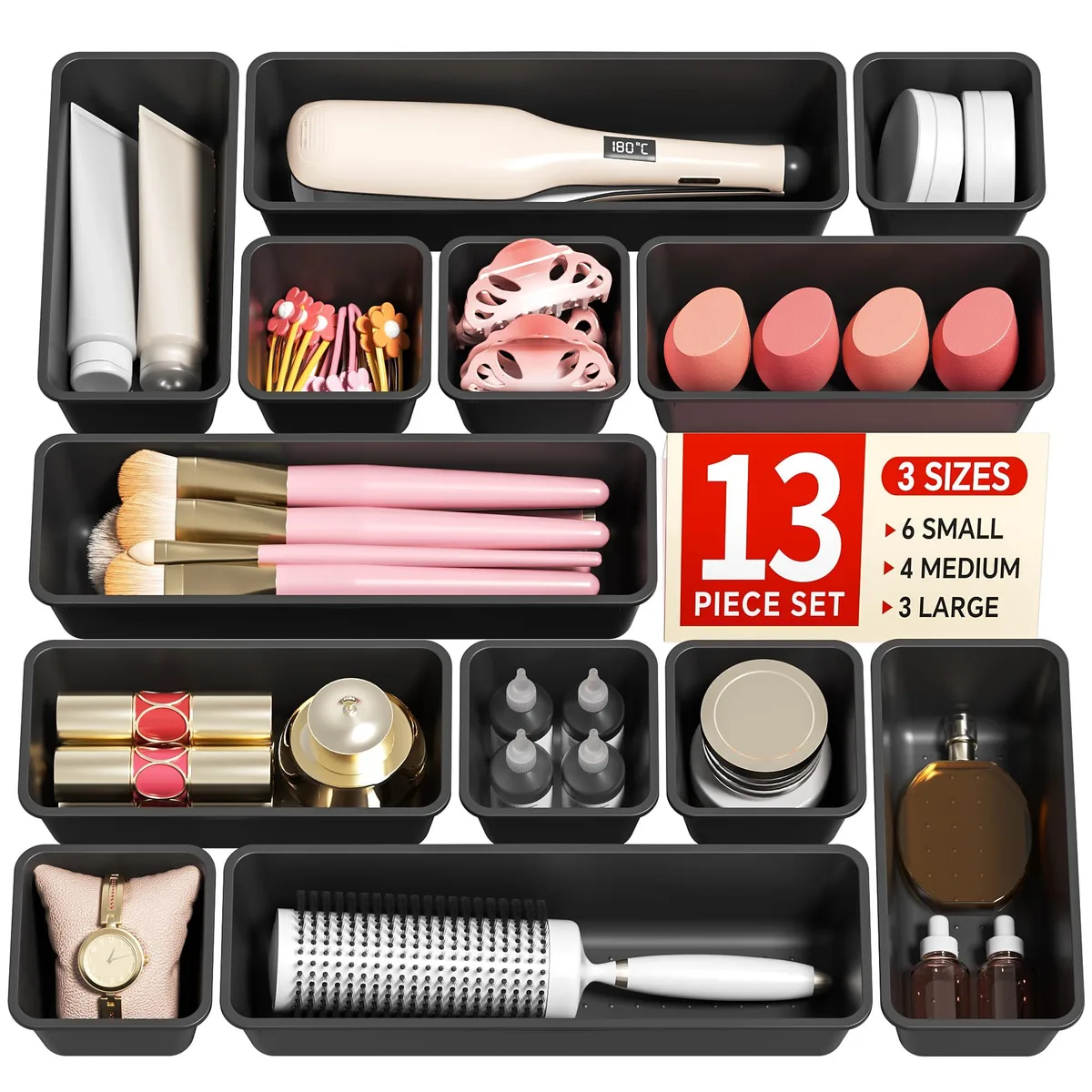 Thirteen black plastic drawer organiser trays in three sizes stacked together