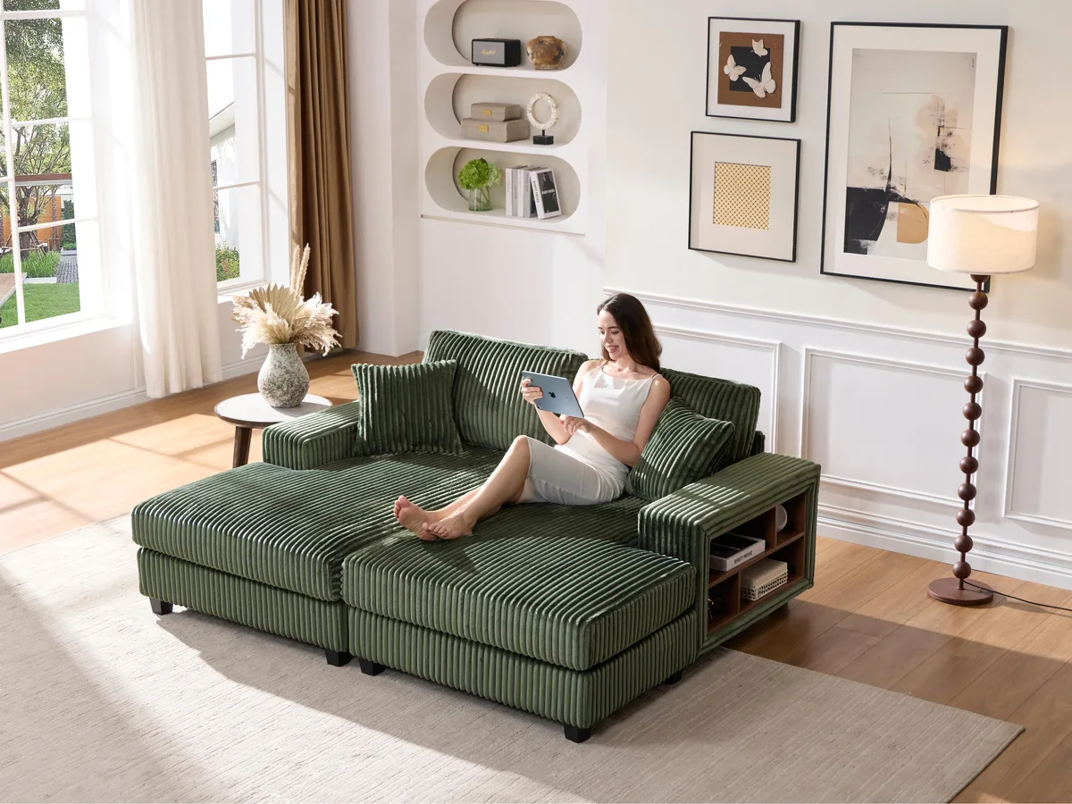 Green corduroy convertible sofa with wood frame and oversized cushions