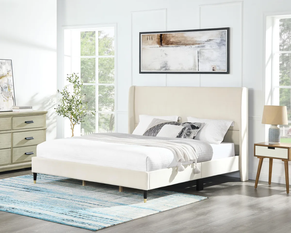 Beige velvet wingback king bed with low platform and cone feet