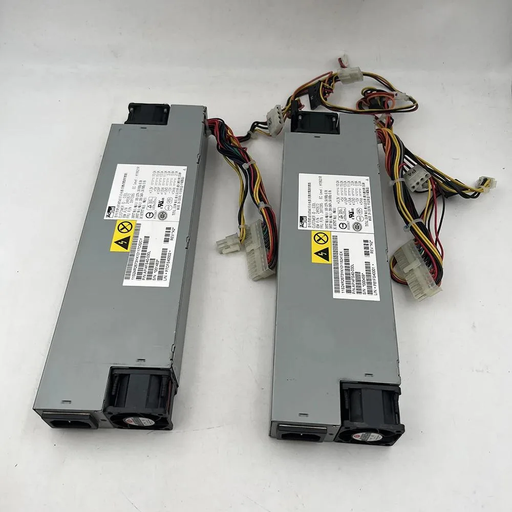 Rectangular metal ATX power supply unit with ventilation grille and cables