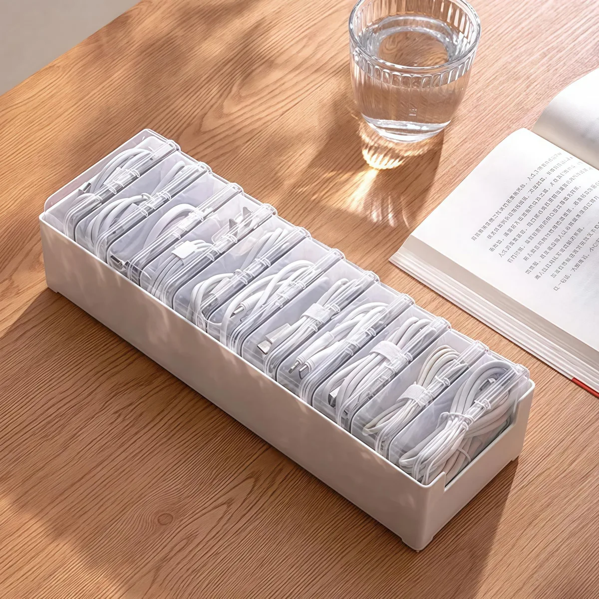White plastic cable organiser with eleven compartments and a switch, 11.8 inches long