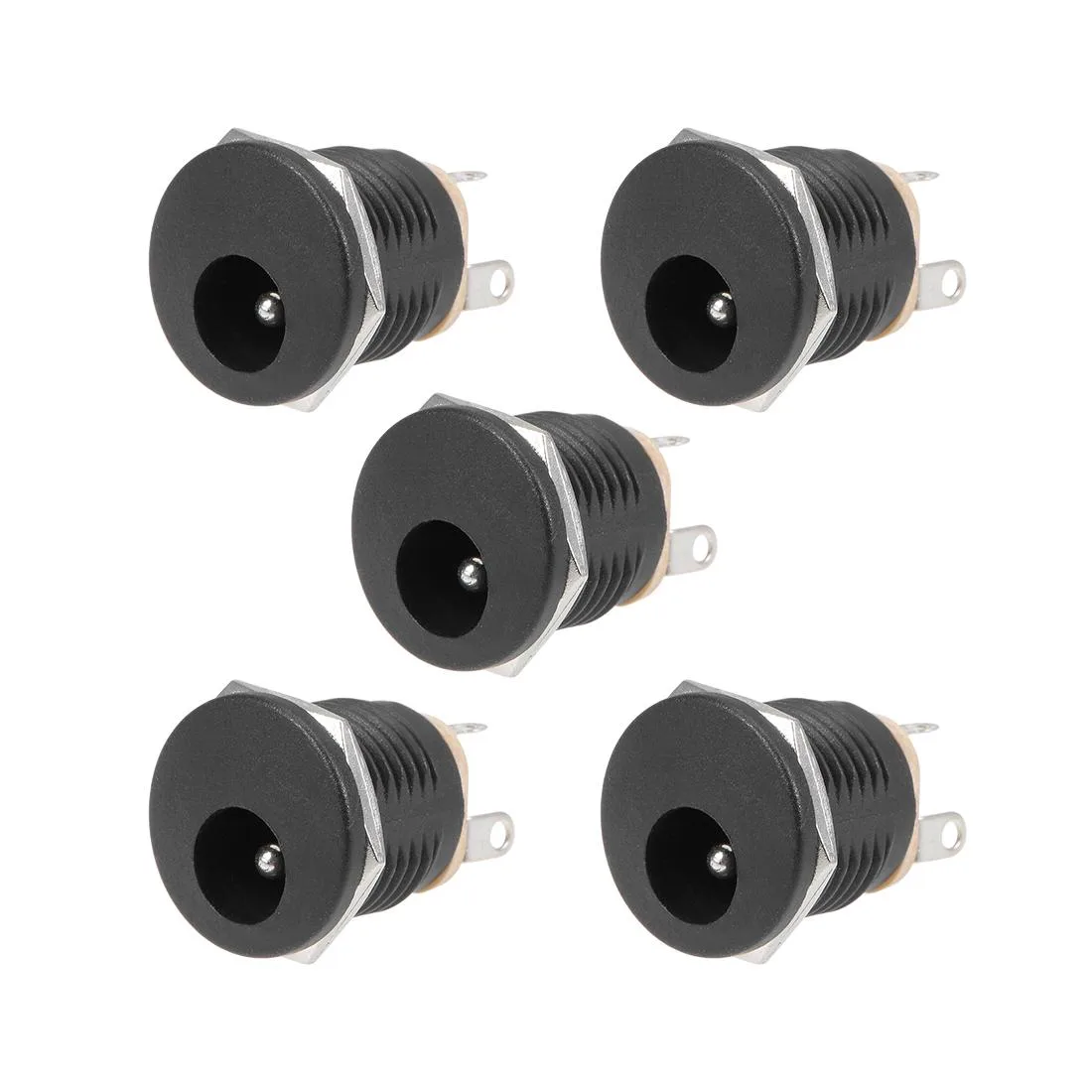 Five cylindrical metal DC power jack sockets with threaded barrels and mounting nuts on a plain surface