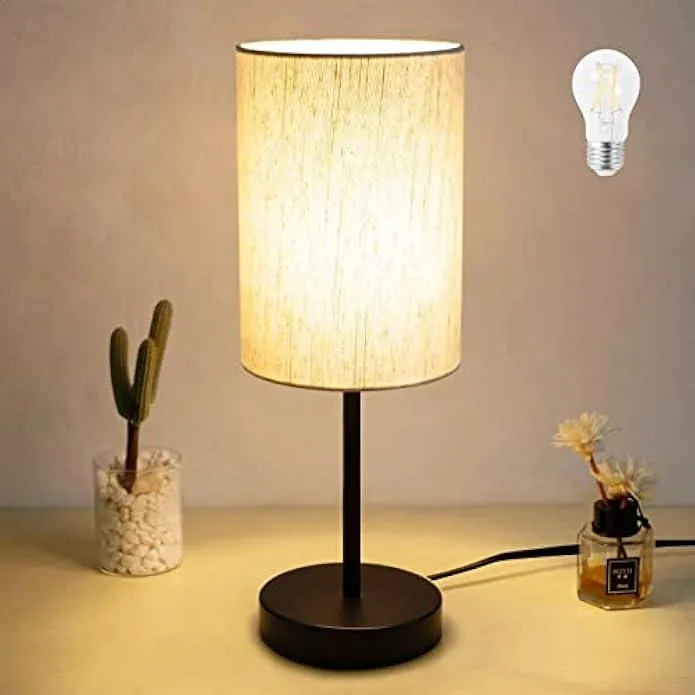 Small round table lamp with white linen shade and circular base, includes warm LED bulb