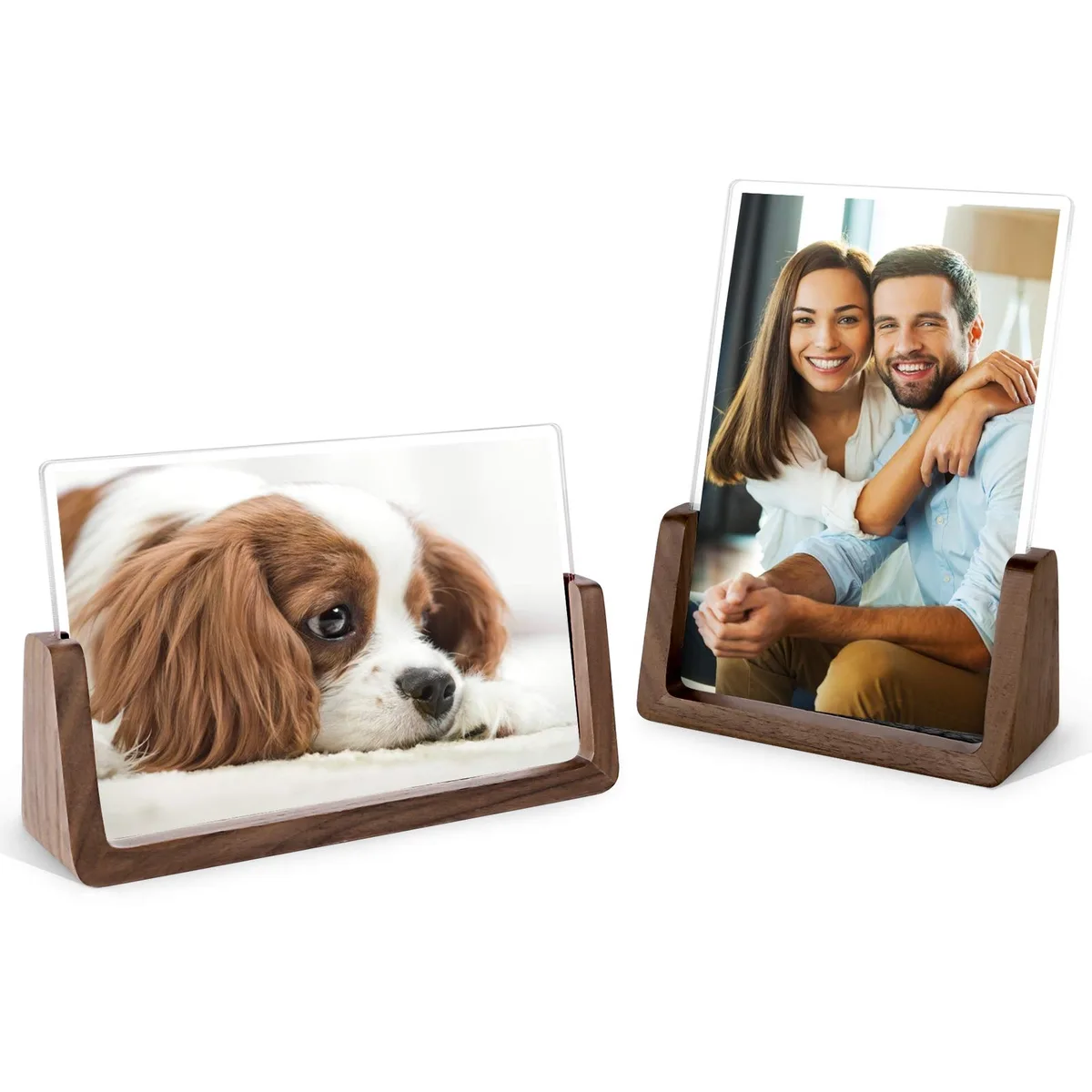Two walnut wood picture frames with clear acrylic covers, one horizontal and one vertical, on a desk